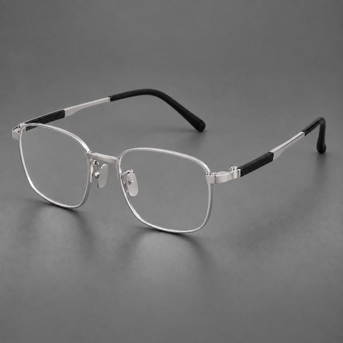 Slim rectangular titanium glasses with broad temples and contrasting dark inserts in Silver, three quarter view