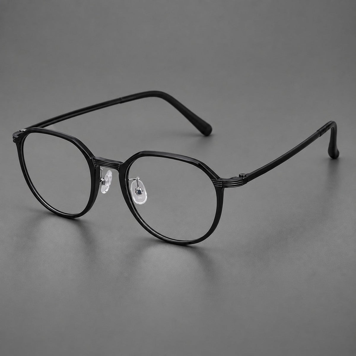 Geometric titanium glasses with flattened corners and a finely ridged bridge in Black, three quarter view