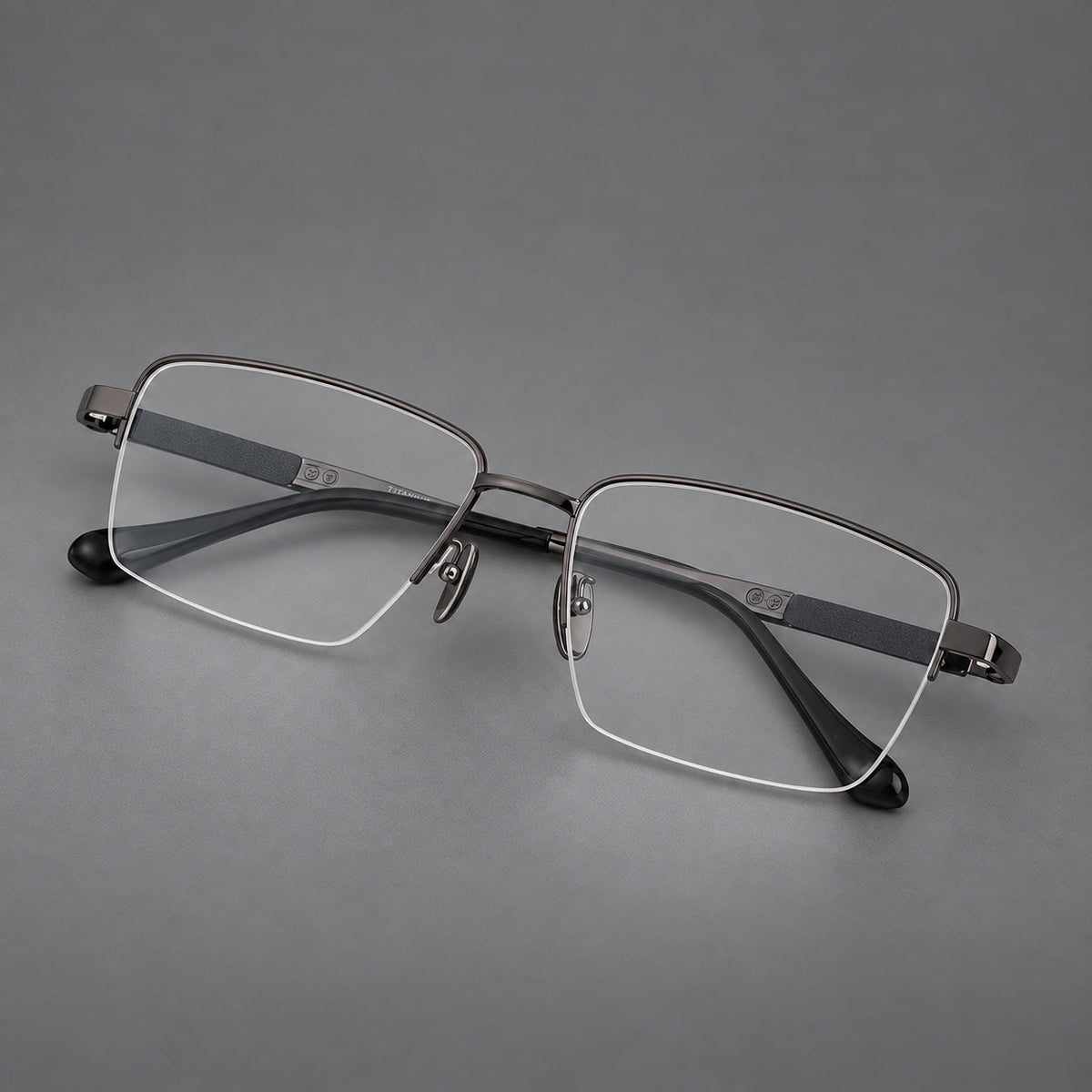 Wide half frame titanium glasses with rectangular lenses and textured temples in Gunmetal, three quarter view