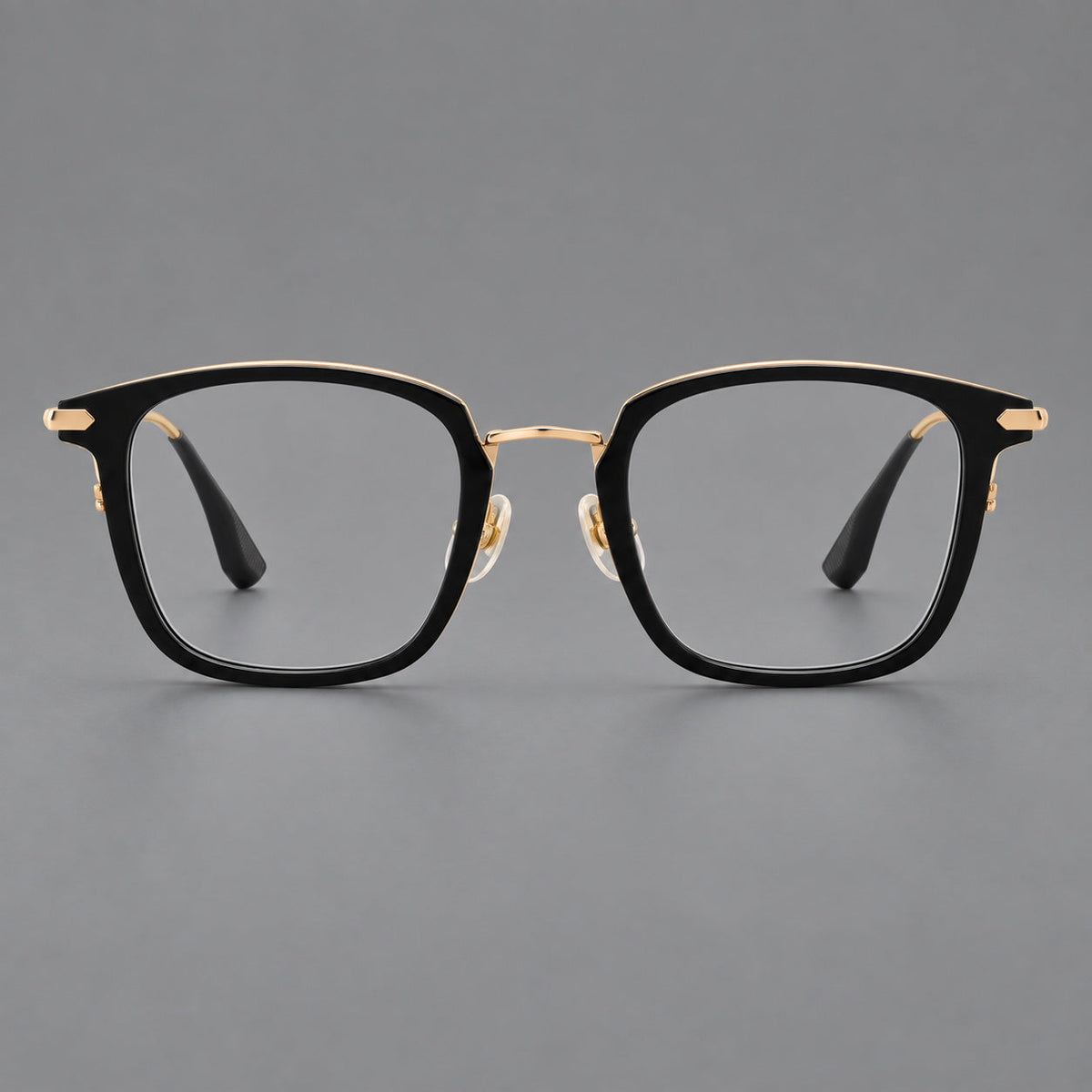 Bold square titanium glasses with a separate bridge and long metal corner accents in Black and Gold, front view