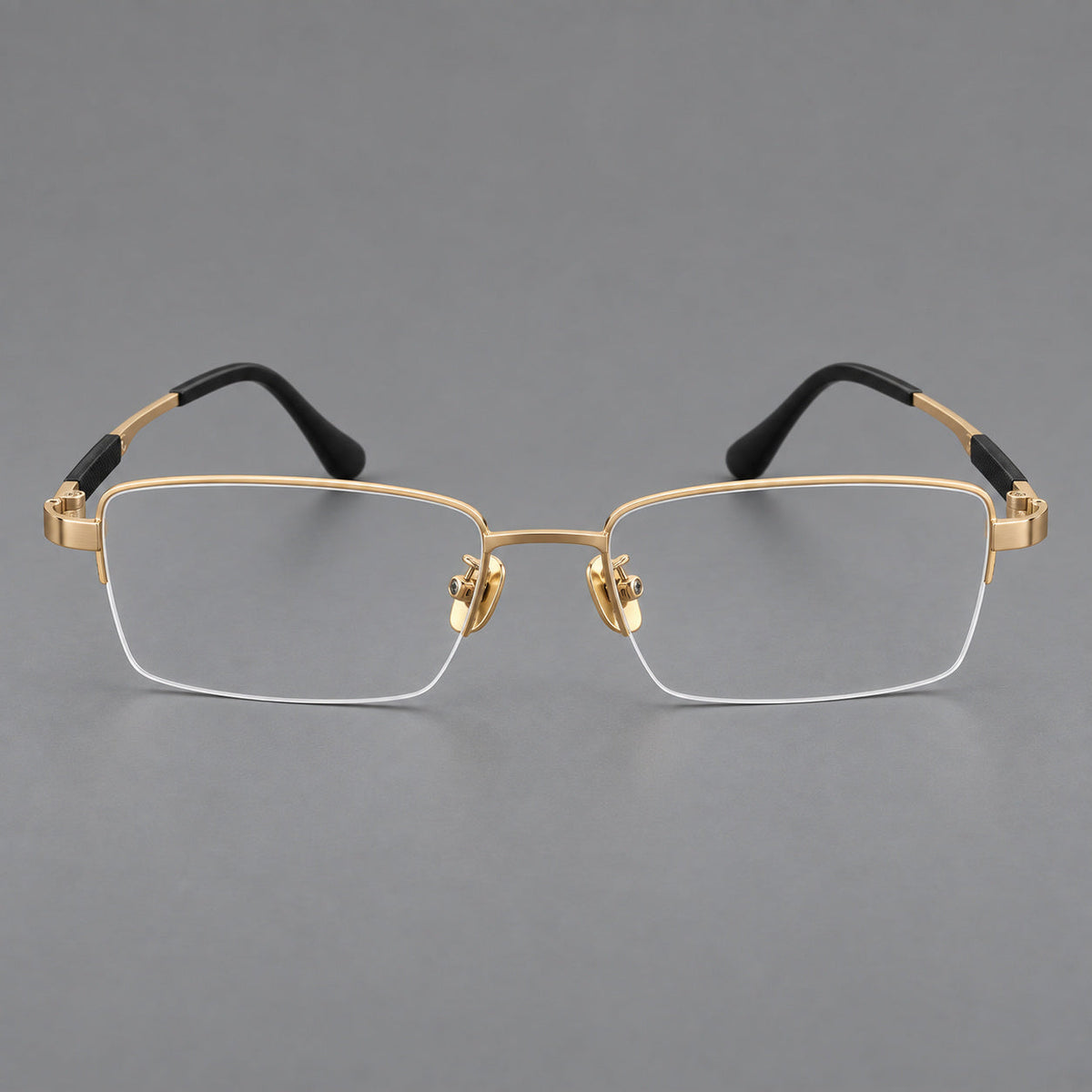 Modern half frame titanium glasses with a narrow bridge and dark temple sections in Gold, front view