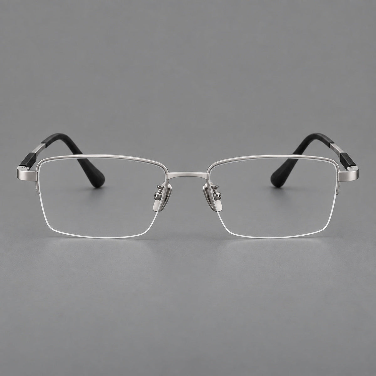 Modern half frame titanium glasses with a narrow bridge and dark temple sections in Silver, front view