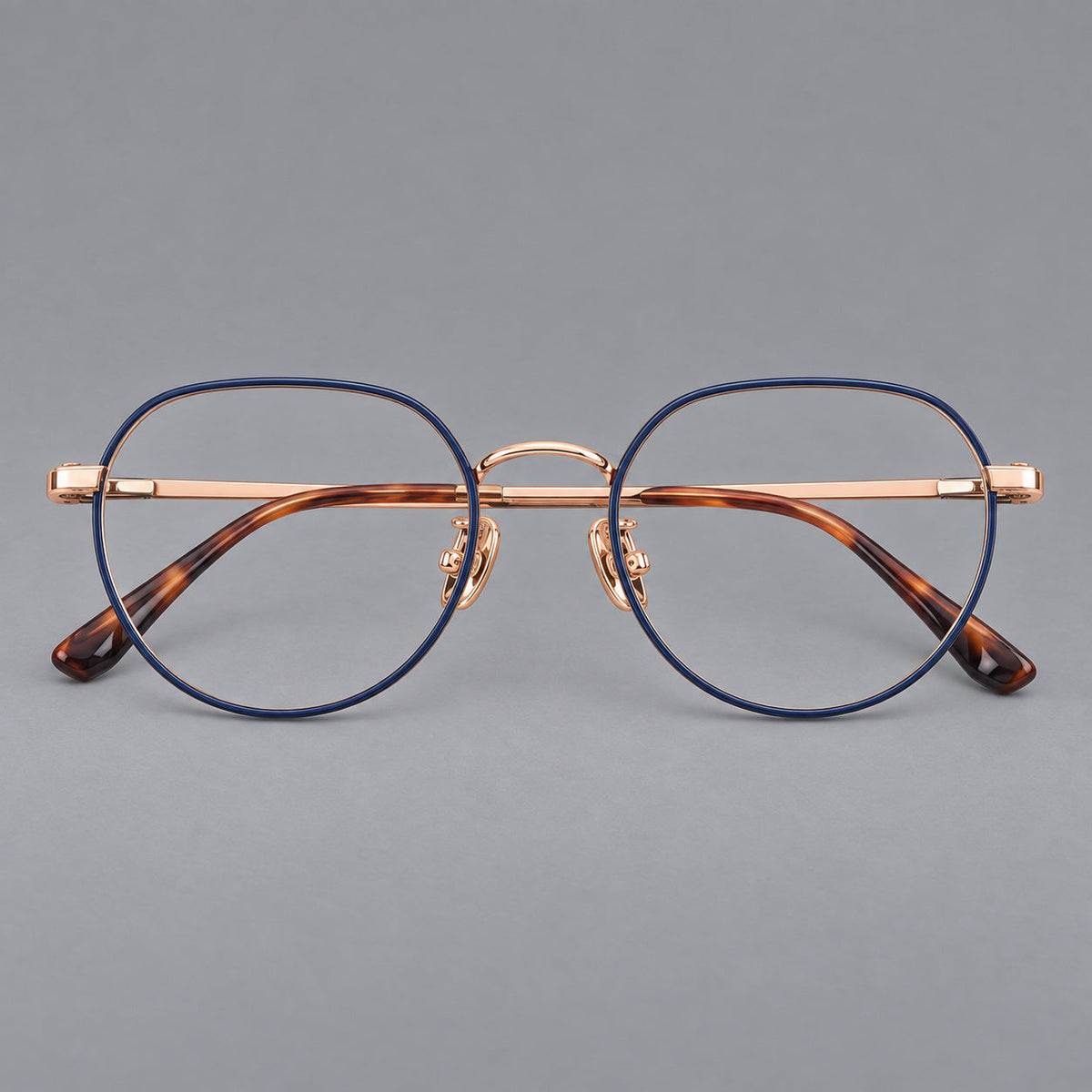 Classic panto titanium glasses with a curved bridge and slim straight temples in Blue and Rose Gold, front view