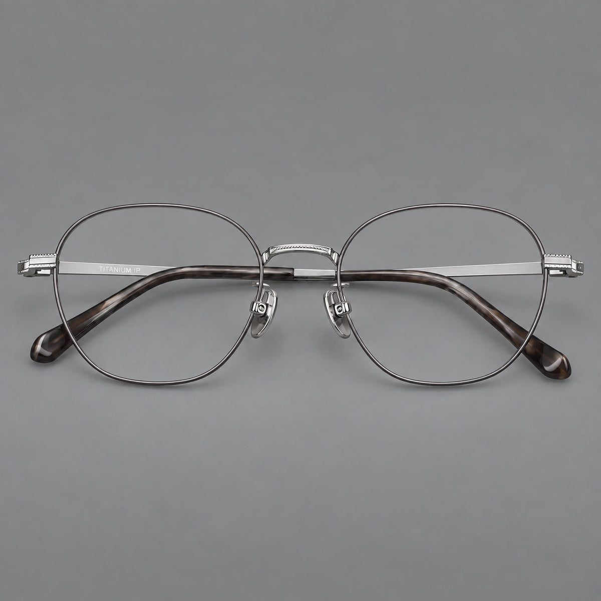 Retro panto titanium glasses with stepped corners and finely engraved temples in Gray and Silver, front view