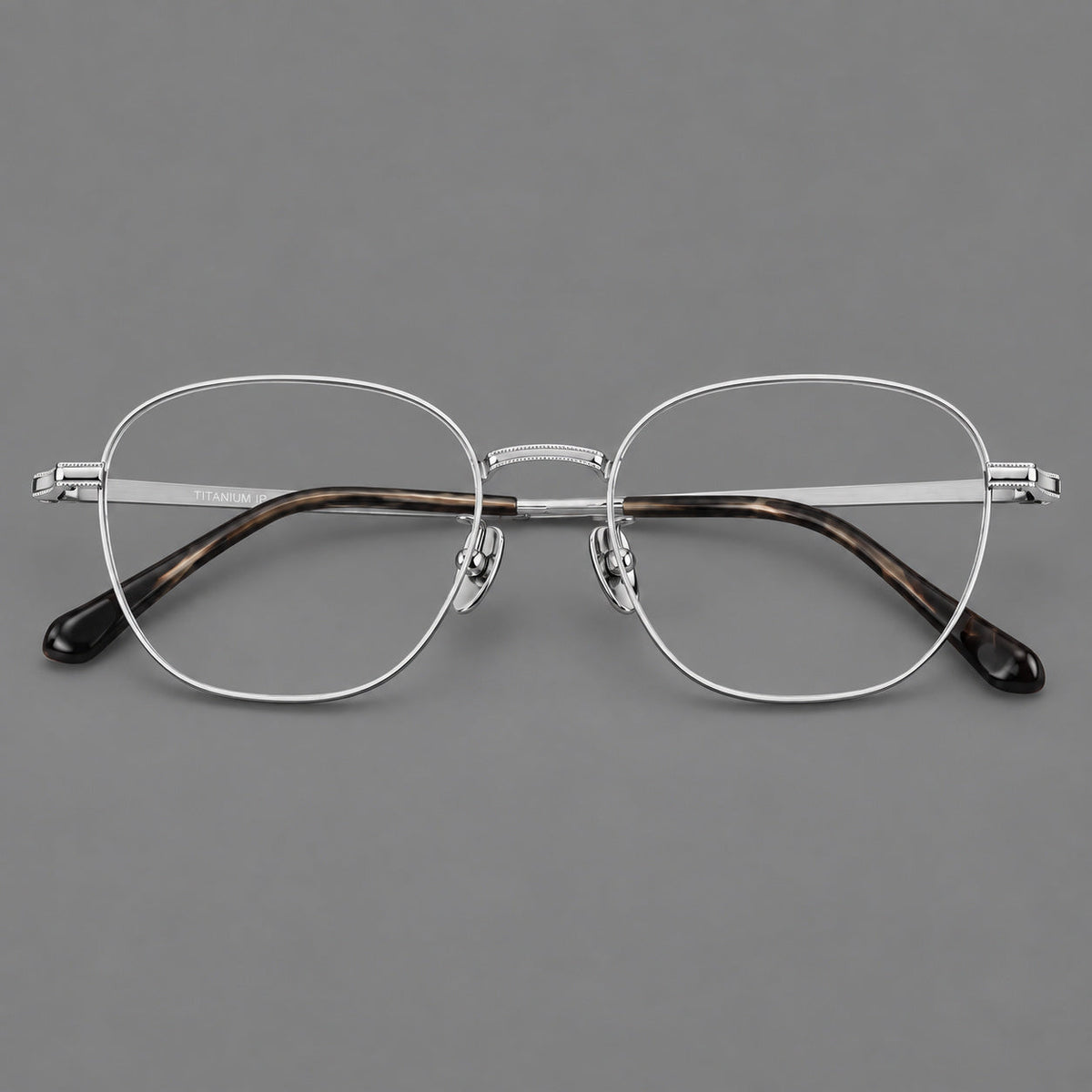 Retro panto titanium glasses with stepped corners and finely engraved temples in Silver, front view