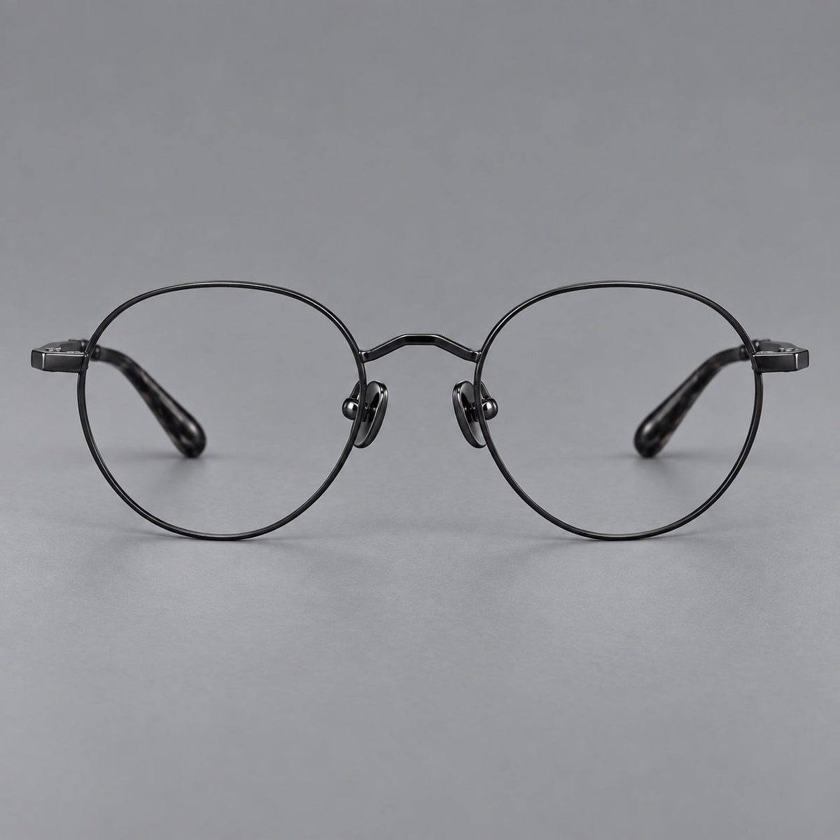 Retro panto titanium glasses with faceted corners and mottled curved temple tips in Black, front view