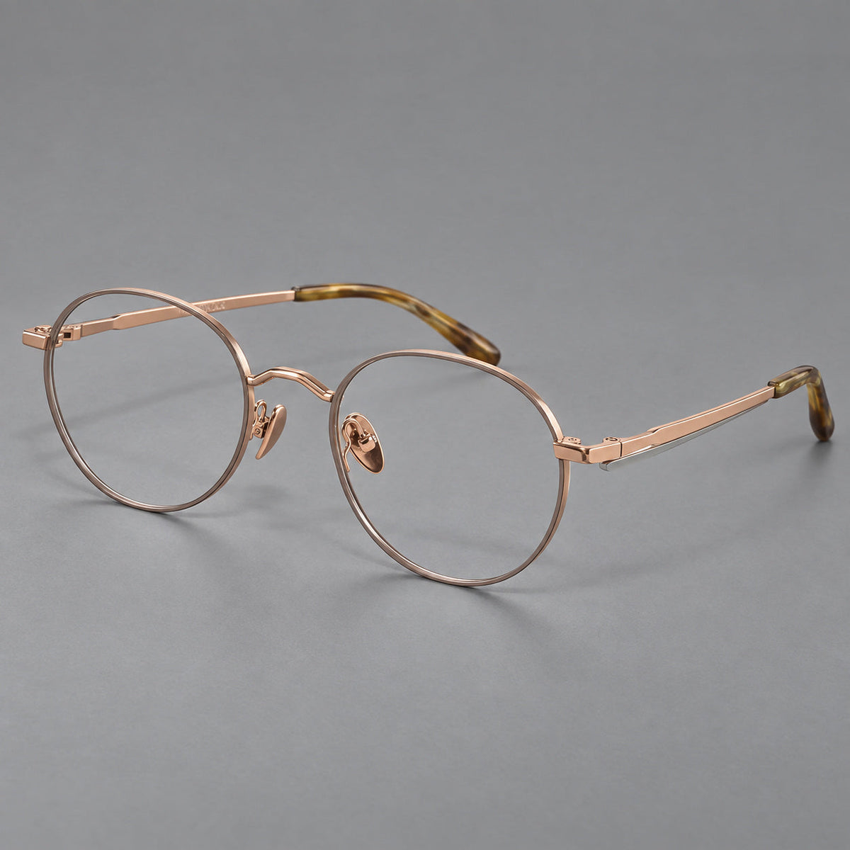 Retro panto titanium glasses with faceted corners and mottled curved temple tips in Gray Brown and Rose Gold, three quarter view
