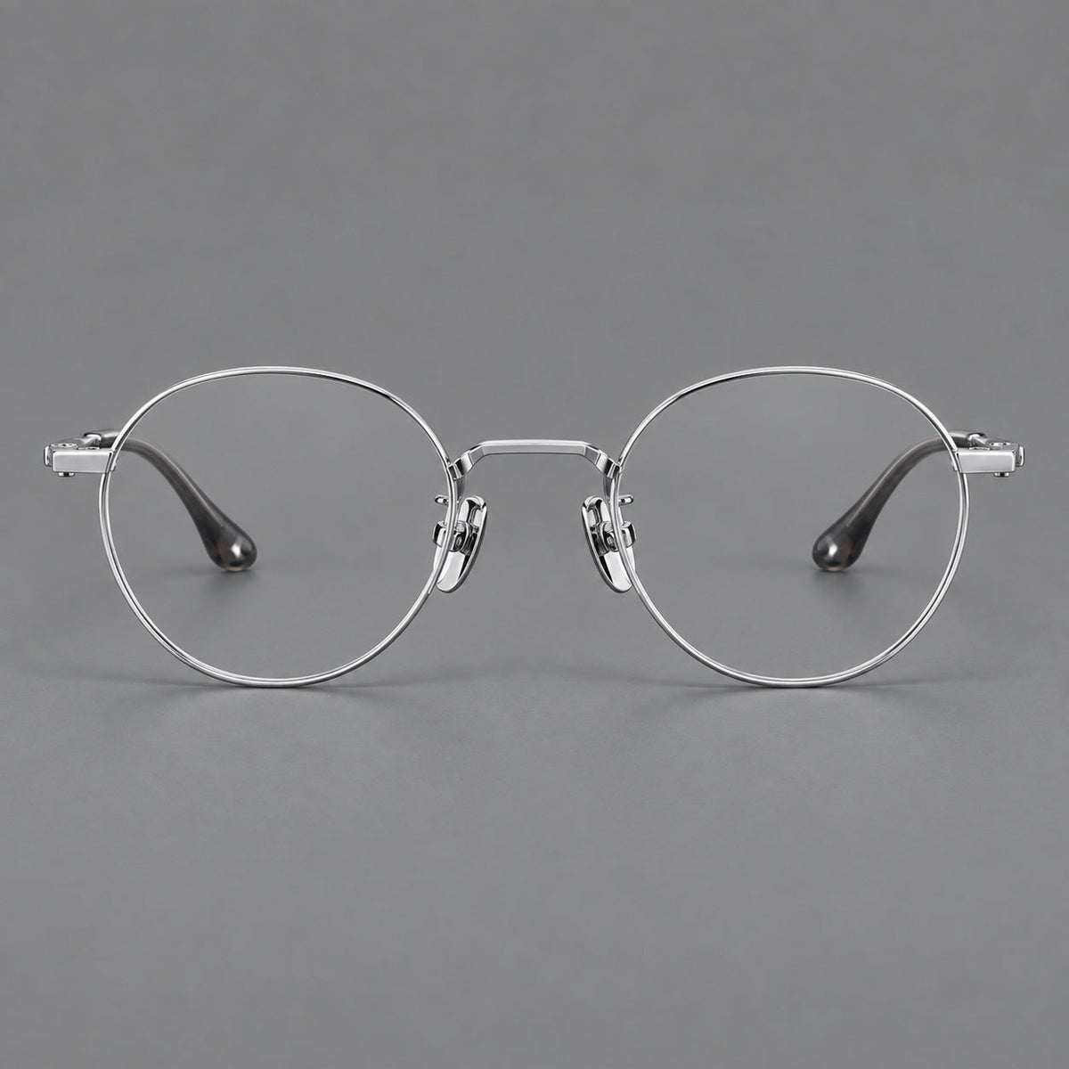 Small panto titanium glasses with an angular bridge and recessed temple details in Silver, front view