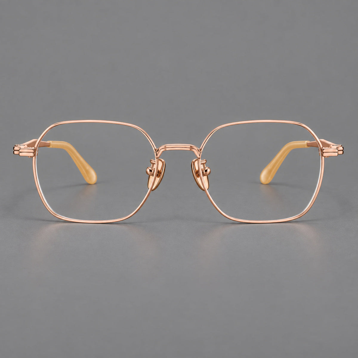 Soft square titanium glasses with an angular bridge and layered corner details in Rose Gold, front view
