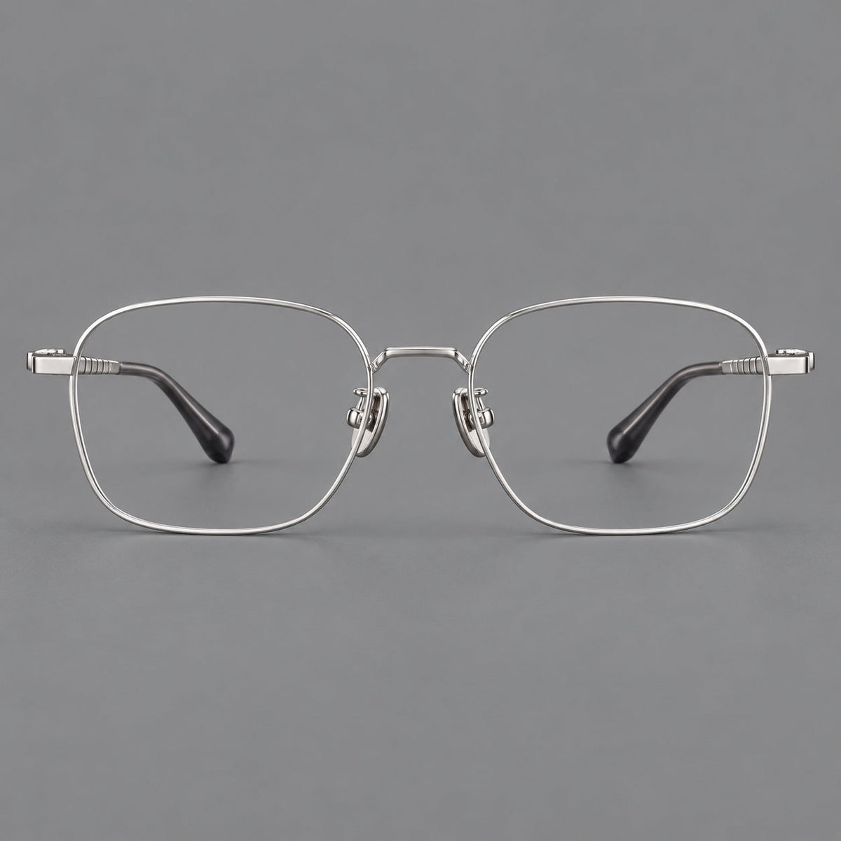 Soft square titanium glasses with a raised bridge and engraved temple bands in Silver, front view