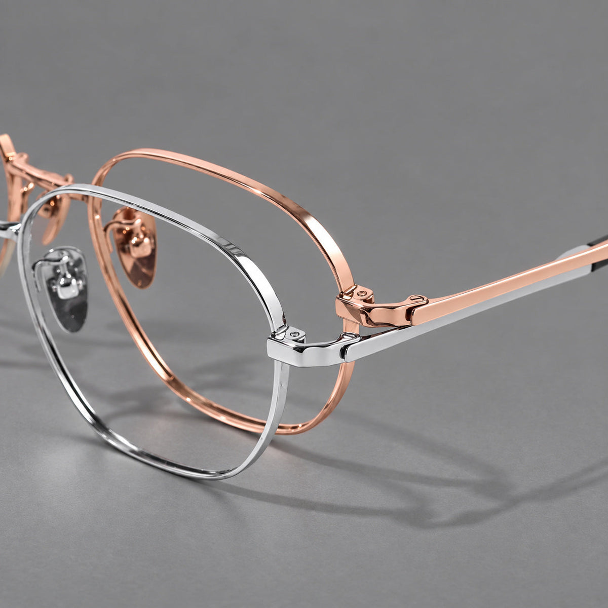 Rounded panto titanium glasses with an angular bridge and broad flat temples, frame details
