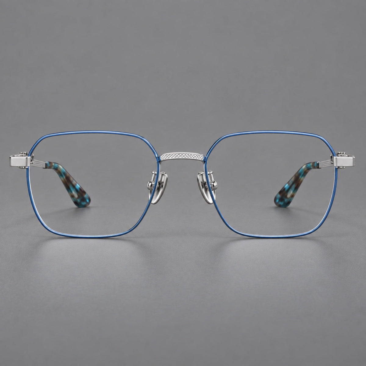 Geometric square titanium glasses with a textured bridge and fine temple grooves in Blue and Silver, front view