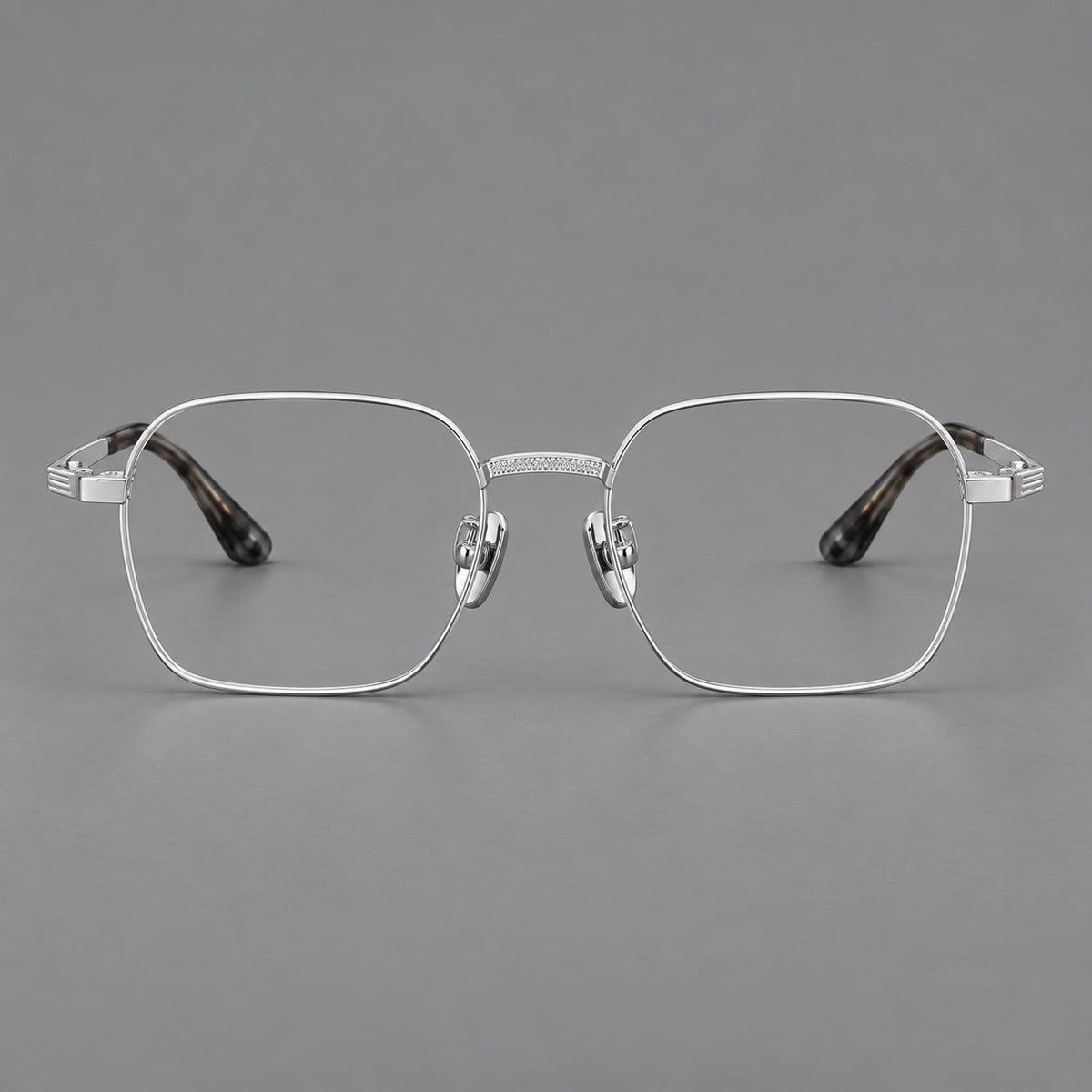 Geometric square titanium glasses with a textured bridge and fine temple grooves in Silver, front view