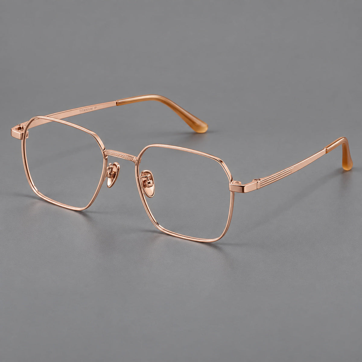 Geometric square titanium glasses with a textured bridge and fine temple grooves in Rose Gold, three quarter view
