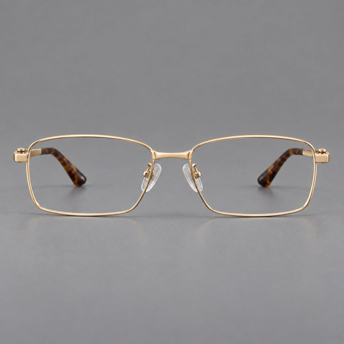 Wide rectangular titanium glasses with a broad bridge and rounded hinge caps in Gold, front view
