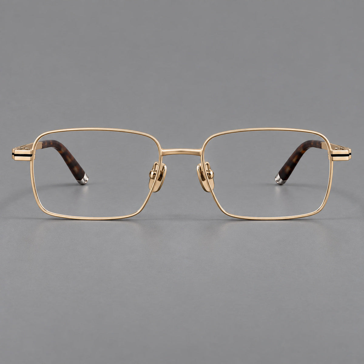 Rectangular titanium glasses with inset corner lines and metal capped temple tips in Gold, front view