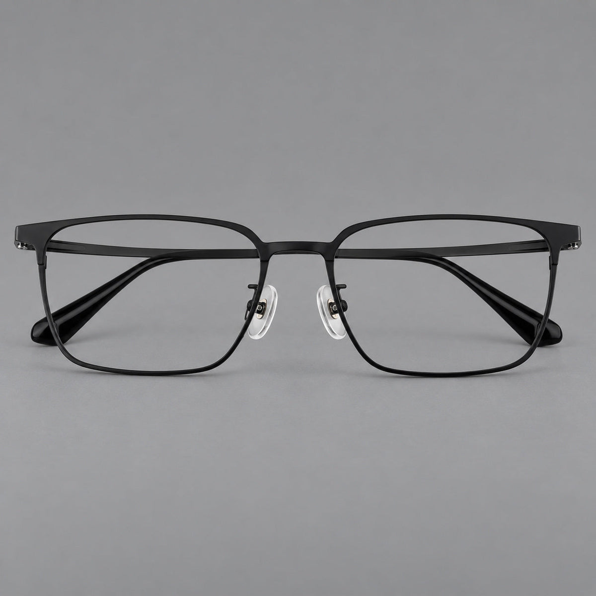 Bold rectangular titanium glasses with strong upper corners and flat metal temples in Black, front view