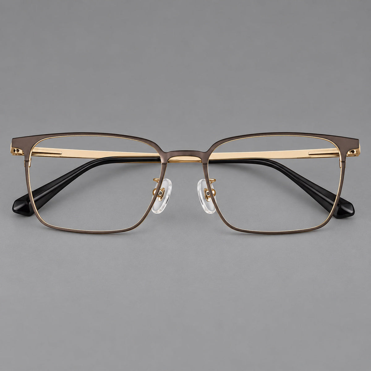 Bold rectangular titanium glasses with strong upper corners and flat metal temples in Gold, front view