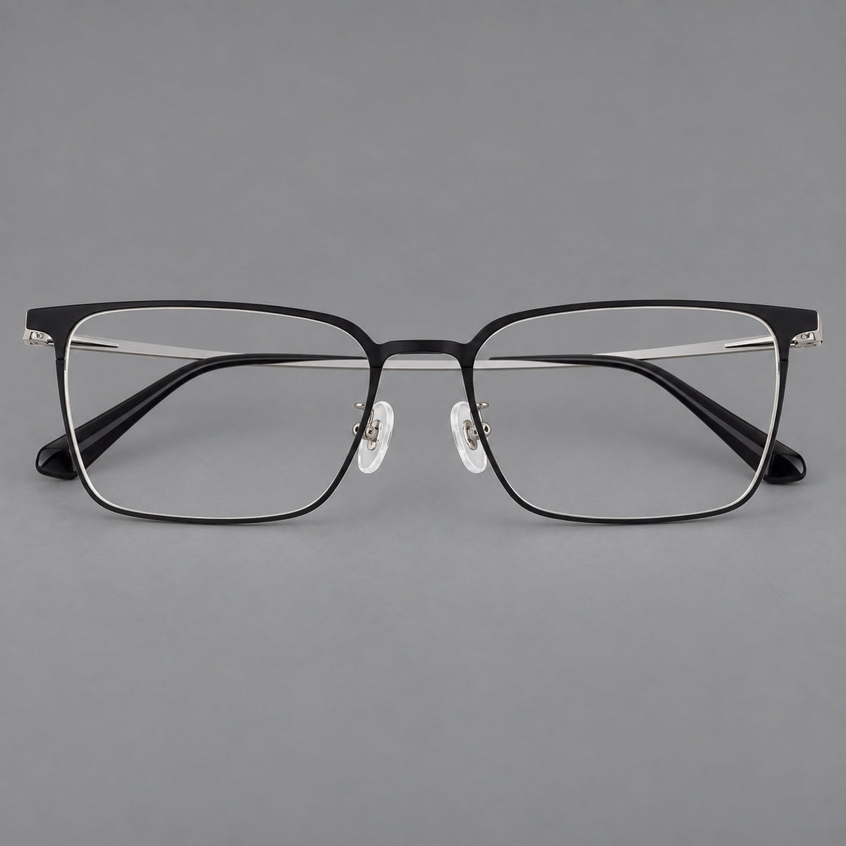 Bold rectangular titanium glasses with strong upper corners and flat metal temples in Black and Silver, front view