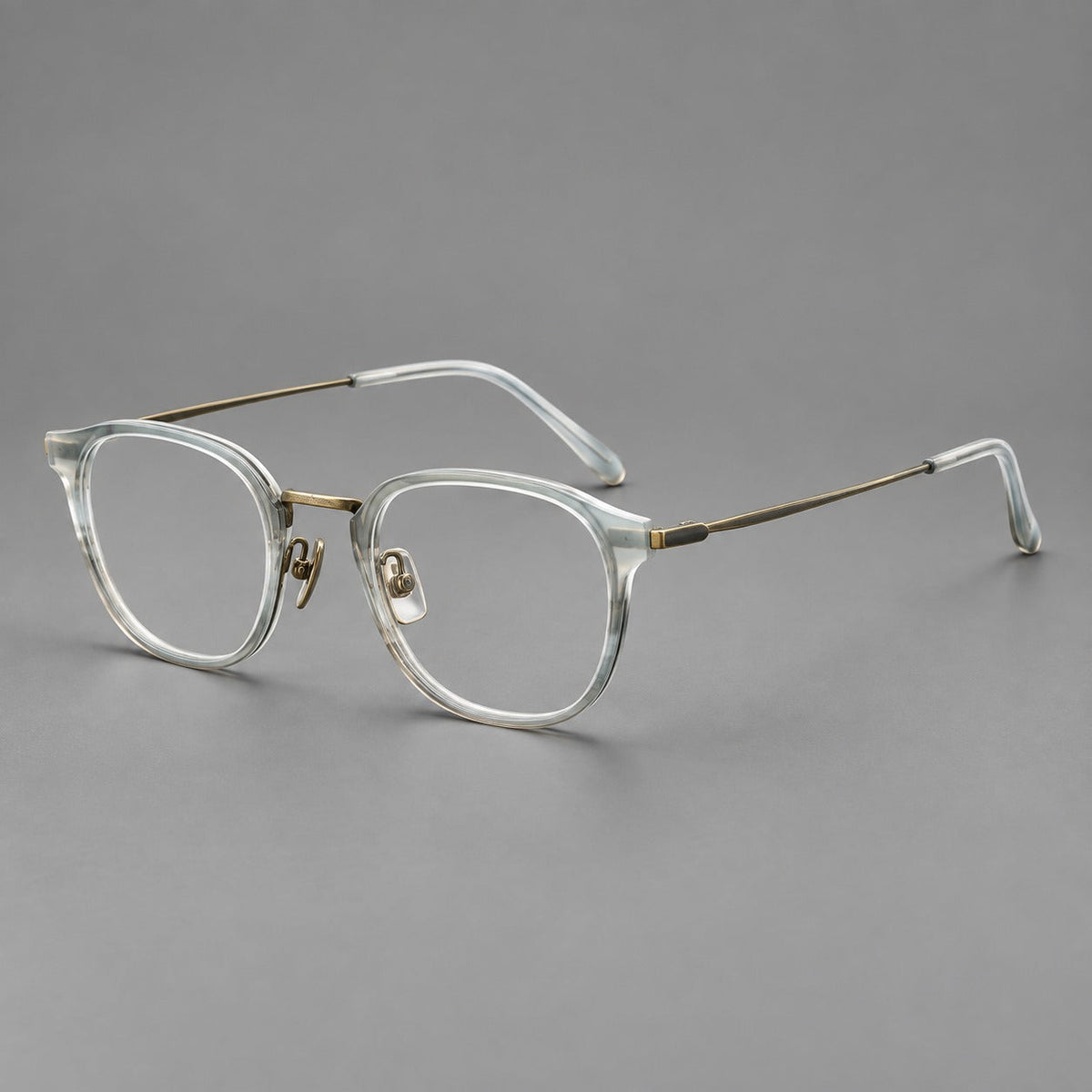 Retro soft square eyeglasses in acetate and titanium with a curved bridge and slender temples in Ice Gray Tortoiseshell / Antique Gold, three quarter view