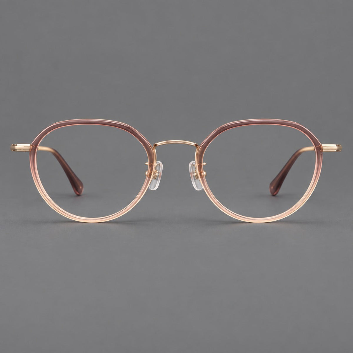 Rounded eyeglasses in acetate and titanium with gently arched brows and engraved metal temples in Pink Tea Gradient / Rose Gold, front view