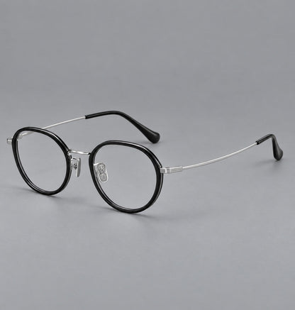 Rounded eyeglasses in acetate and titanium with gently arched brows and engraved metal temples in Black / Silver, three quarter view additional product view