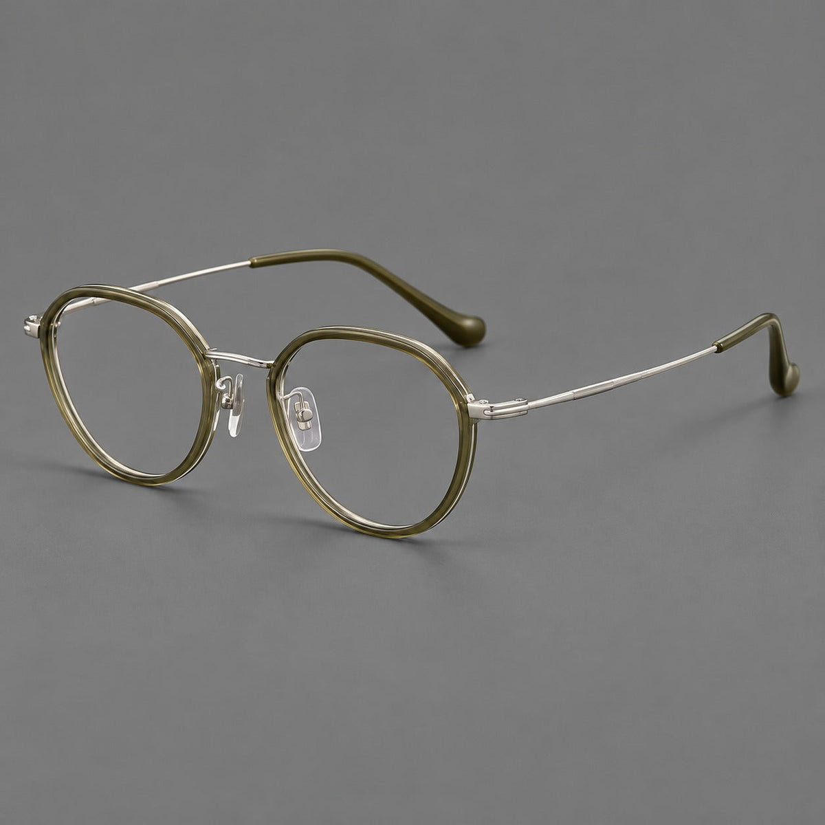 Rounded eyeglasses in acetate and titanium with gently arched brows and engraved metal temples in Gray Green / Silver, three quarter view