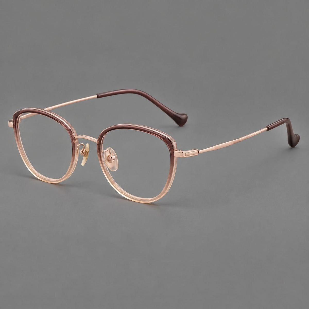 Upswept eyeglasses in acetate and titanium with softly rounded rims and tapered metal temples in Pink Tea Gradient / Rose Gold, three quarter view