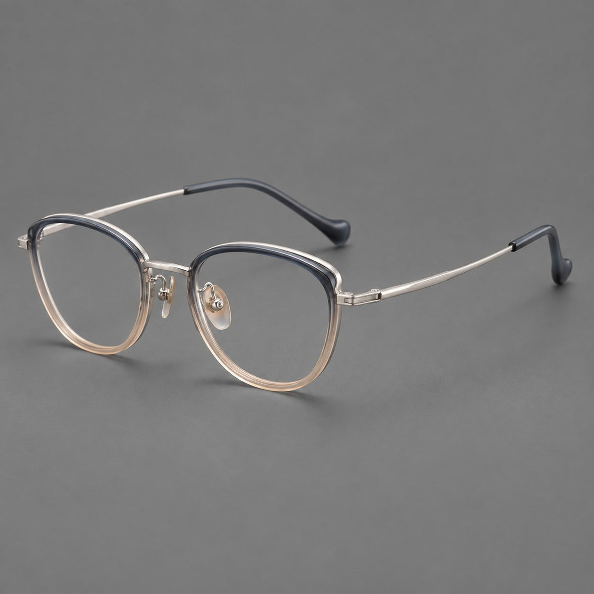 Upswept eyeglasses in acetate and titanium with softly rounded rims and tapered metal temples in Blue Tea Gradient / Gunmetal, three quarter view