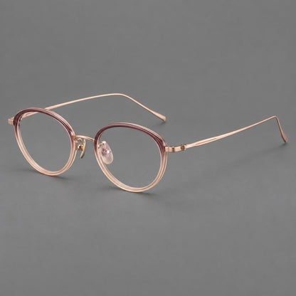 Round eyeglasses in acetate and titanium with a slim curved bridge and fine metal temples in Pink Tea Gradient / Rose Gold, three quarter view front view
