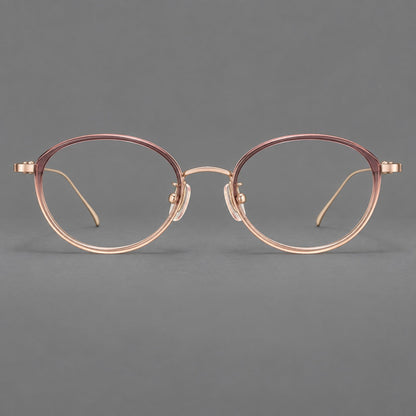 Round eyeglasses in acetate and titanium with a slim curved bridge and fine metal temples in Pink Tea Gradient / Rose Gold, front view frame detail