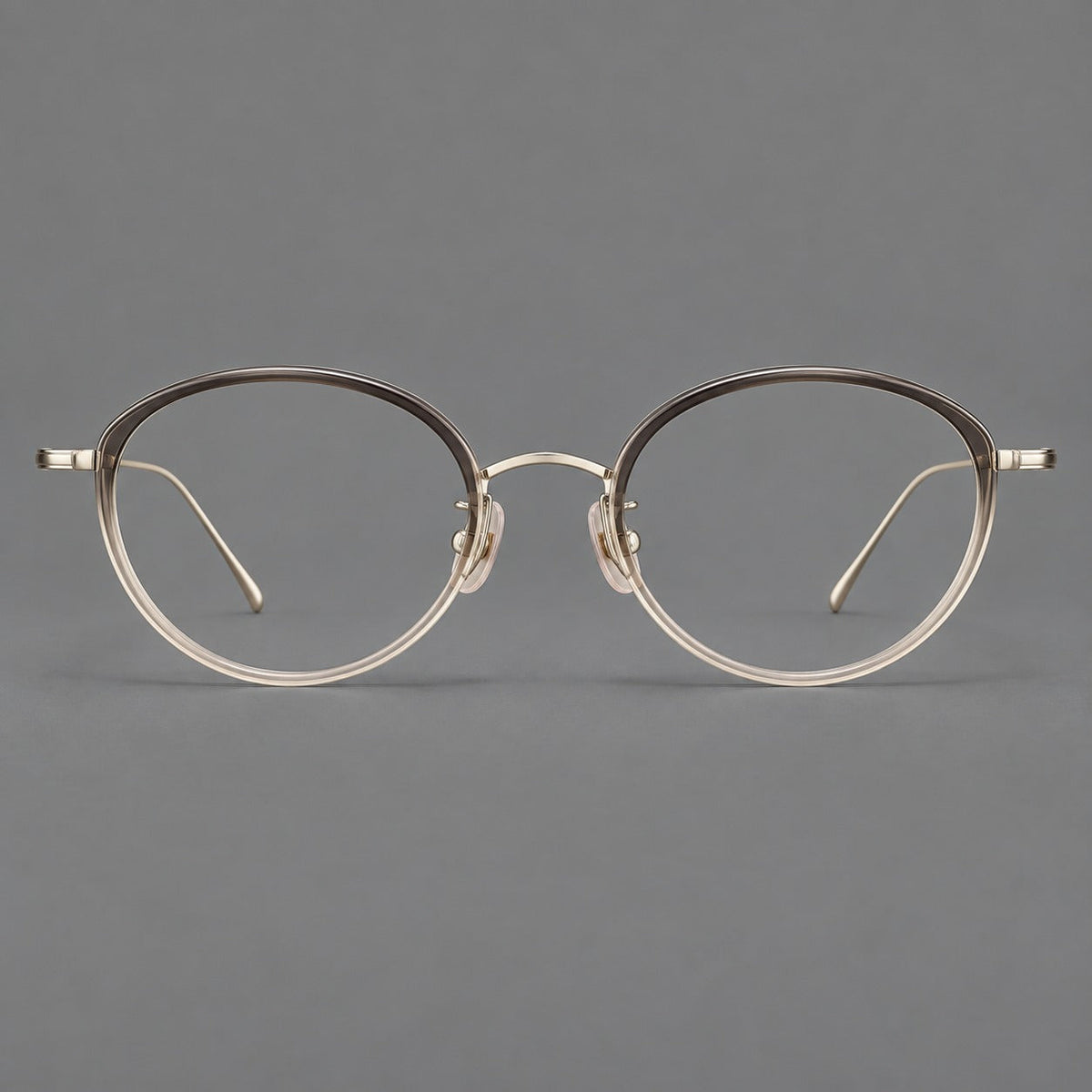Round eyeglasses in acetate and titanium with a slim curved bridge and fine metal temples in Gray Tea Gradient / Gold, front view