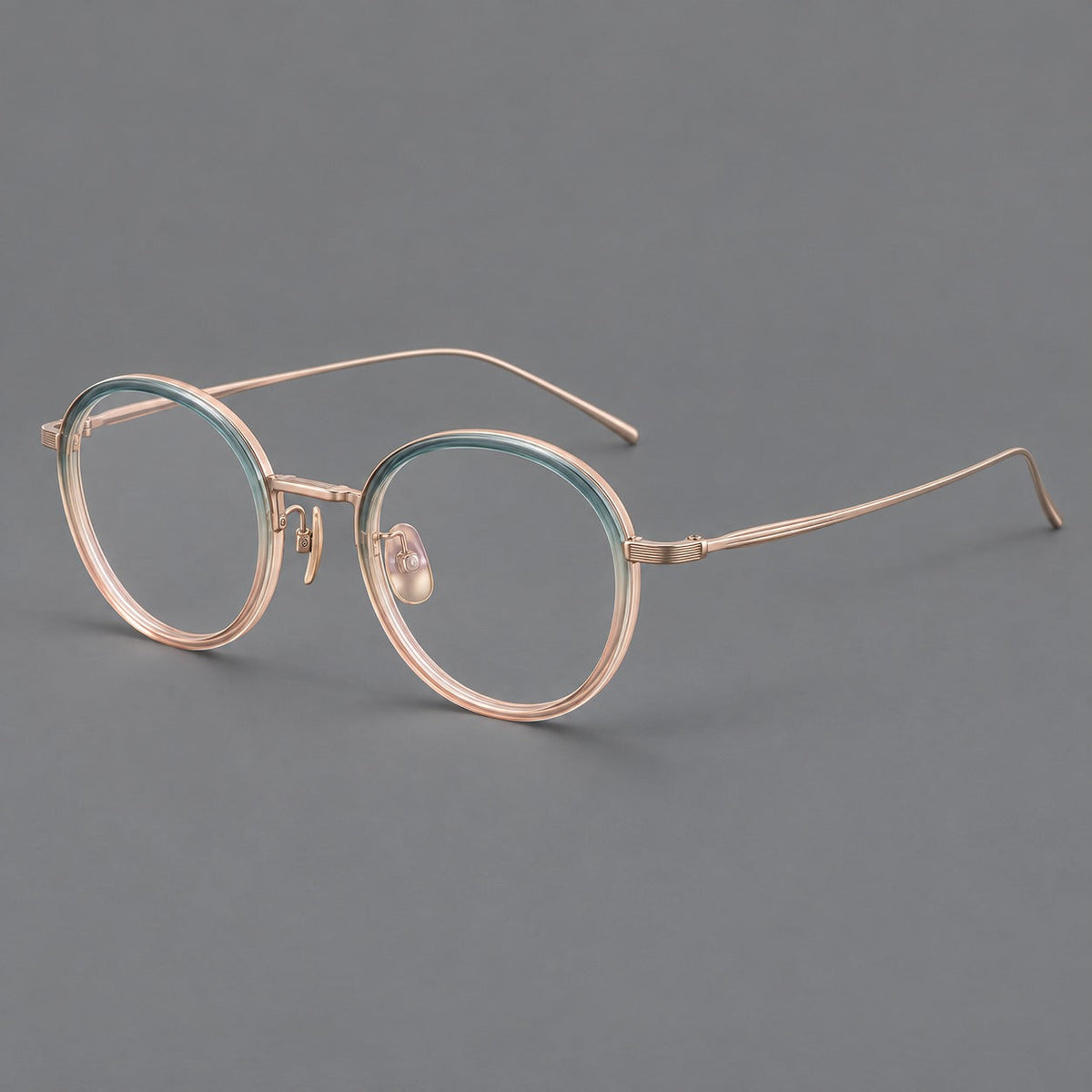 Classic round eyeglasses in acetate and titanium with slim rims and textured metal temples in Blue Tea Gradient / Rose Gold, three quarter view