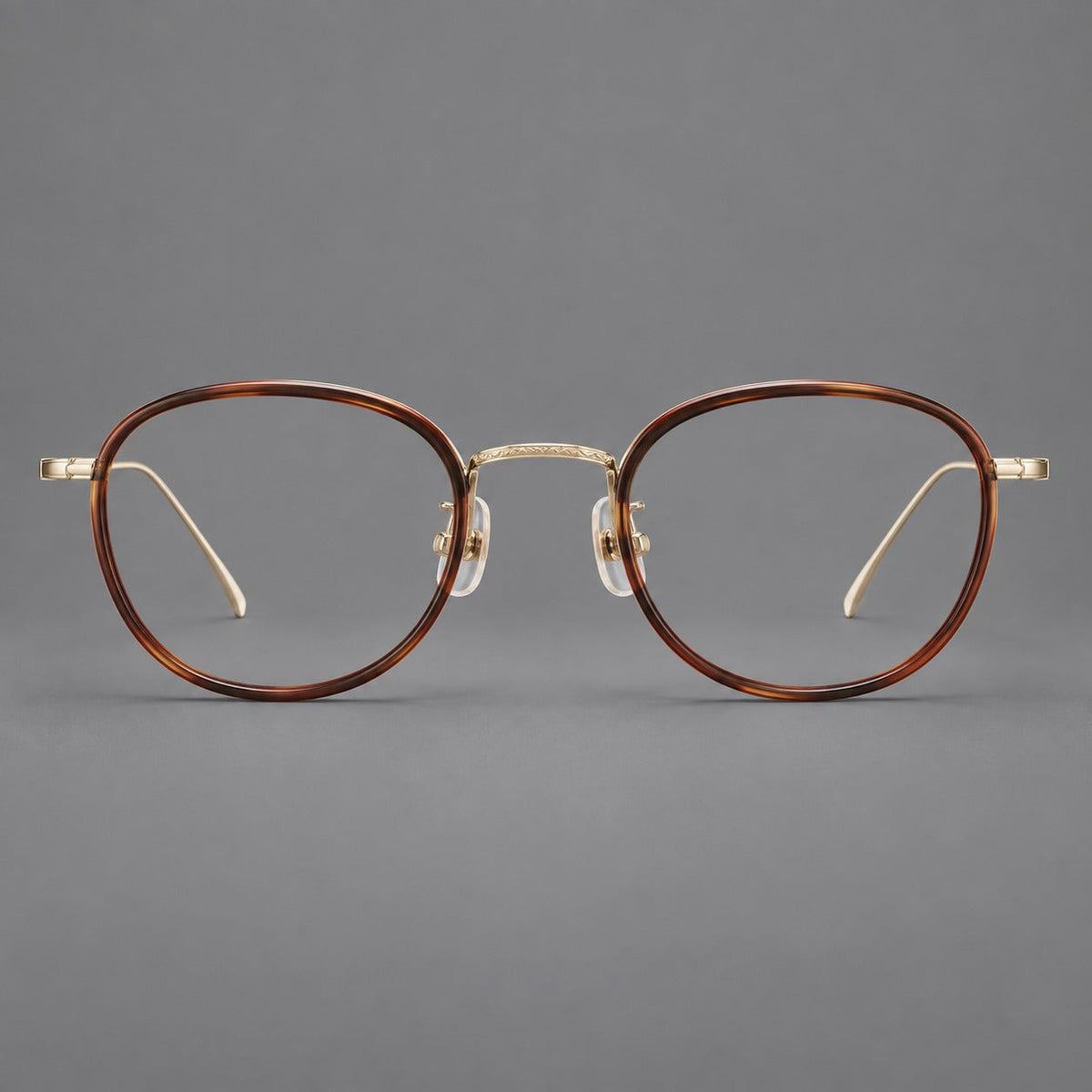 Vintage round eyeglasses in acetate and titanium with an engraved bridge and slender temples in Tortoiseshell / Light Gold, front view