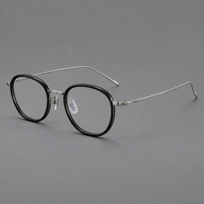Vintage round eyeglasses in acetate and titanium with an engraved bridge and slender temples in Glossy Black / Gunmetal, three quarter view additional product view