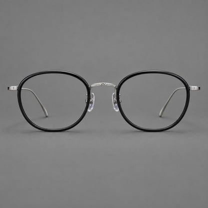 Vintage round eyeglasses in acetate and titanium with an engraved bridge and slender temples in Glossy Black / Gunmetal, front view additional product view