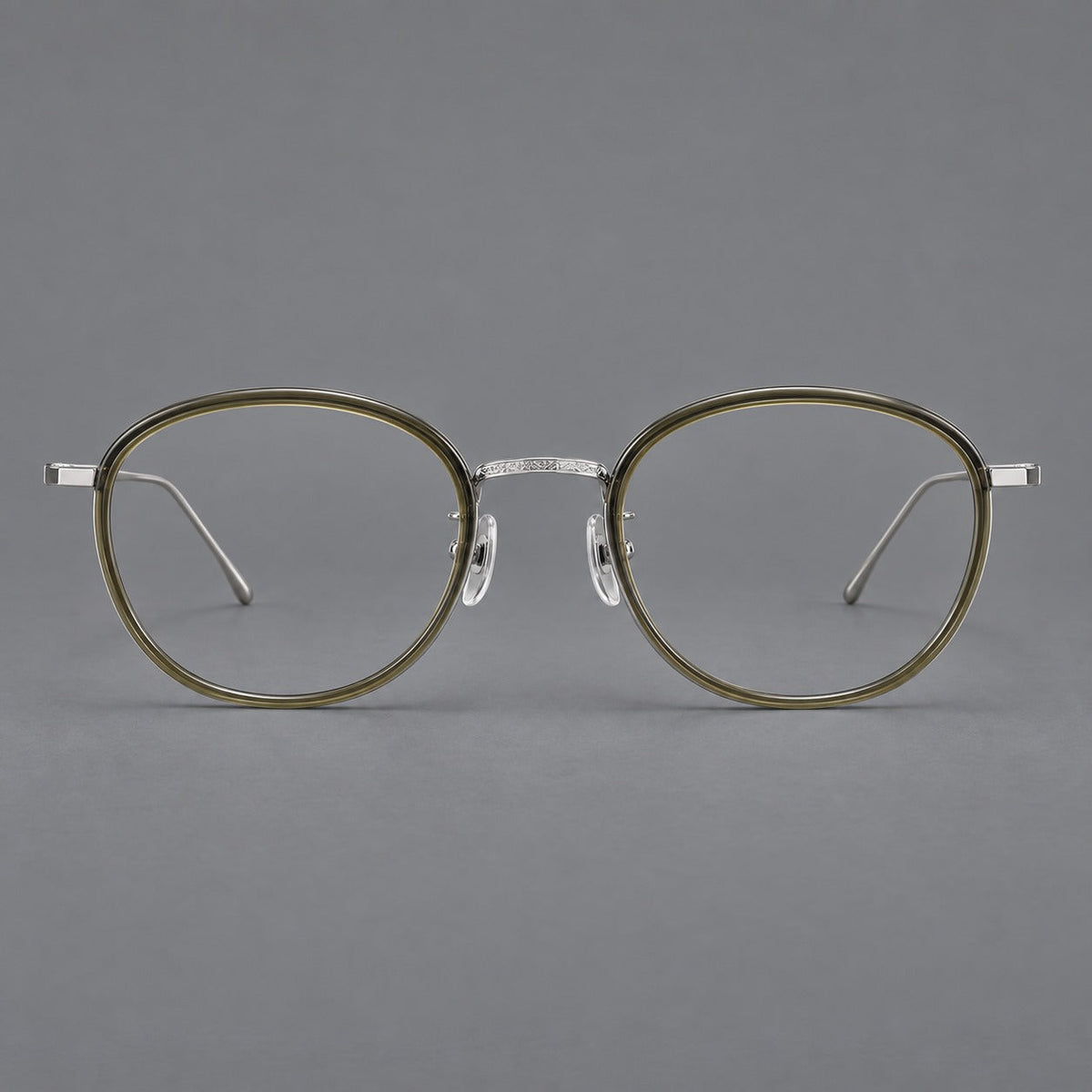 Vintage round eyeglasses in acetate and titanium with an engraved bridge and slender temples in Tea Green / Matte Silver, front view