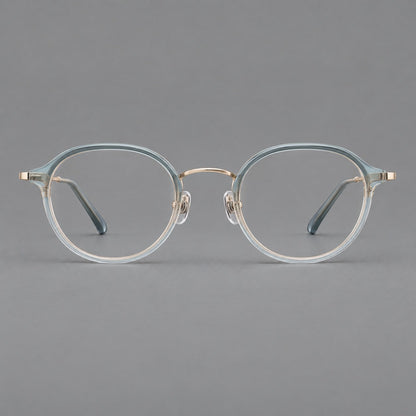 Softly rounded eyeglasses in acetate and titanium with a curved bridge and engraved temples in Ice Blue Gray / Gold, front view side view