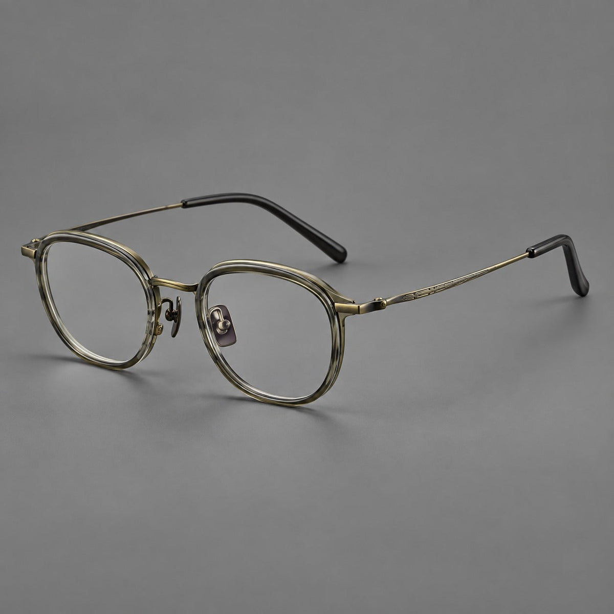Soft square eyeglasses in acetate and titanium with rounded corners and decorative metal temples in Ice Gray Tortoiseshell / Antique Gold, three quarter view