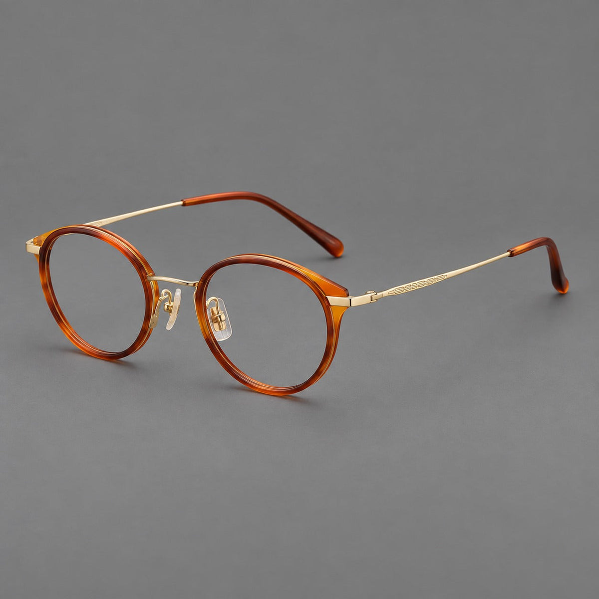 Retro panto eyeglasses in acetate and titanium with an arched bridge and engraved metal temples in Amber Tortoiseshell / Light Gold, three quarter view