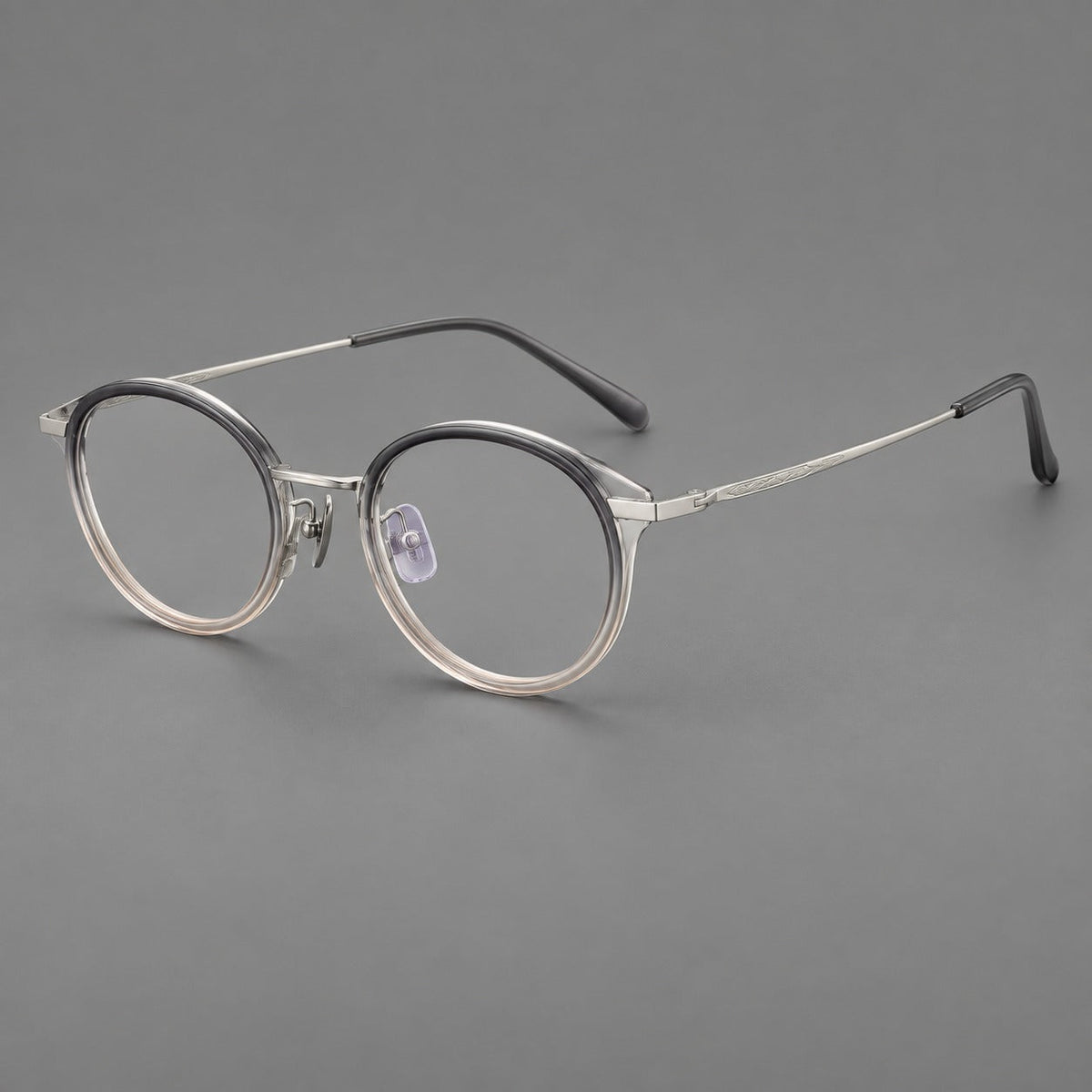 Retro panto eyeglasses in acetate and titanium with an arched bridge and engraved metal temples in Gray Green Gradient / Silver, three quarter view