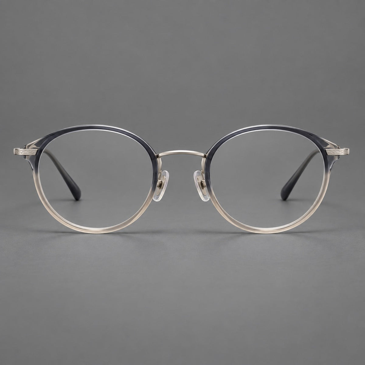 Retro panto eyeglasses in acetate and titanium with an arched bridge and engraved metal temples in Gray Blue Tea Gradient / Light Gunmetal, front view