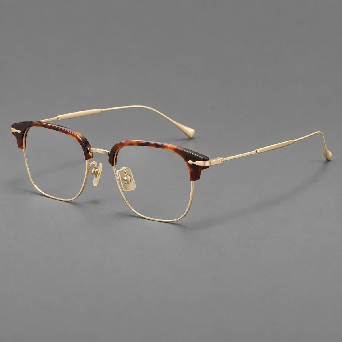 Browline eyeglasses in acetate and titanium with slim metal lower rims and decorative corners in Tortoiseshell / Gold, three quarter view