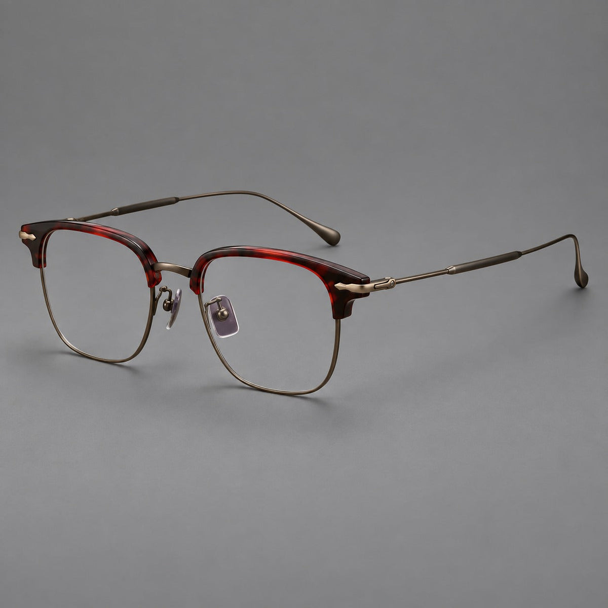 Browline eyeglasses in acetate and titanium with slim metal lower rims and decorative corners in Red Tortoiseshell / Antique Bronze, three quarter view