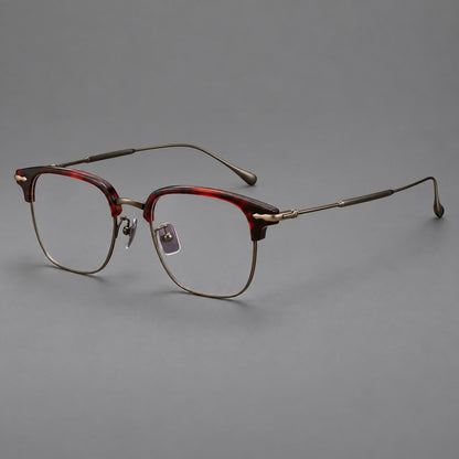 Browline eyeglasses in acetate and titanium with slim metal lower rims and decorative corners in Red Tortoiseshell / Antique Bronze, three quarter view lens detail