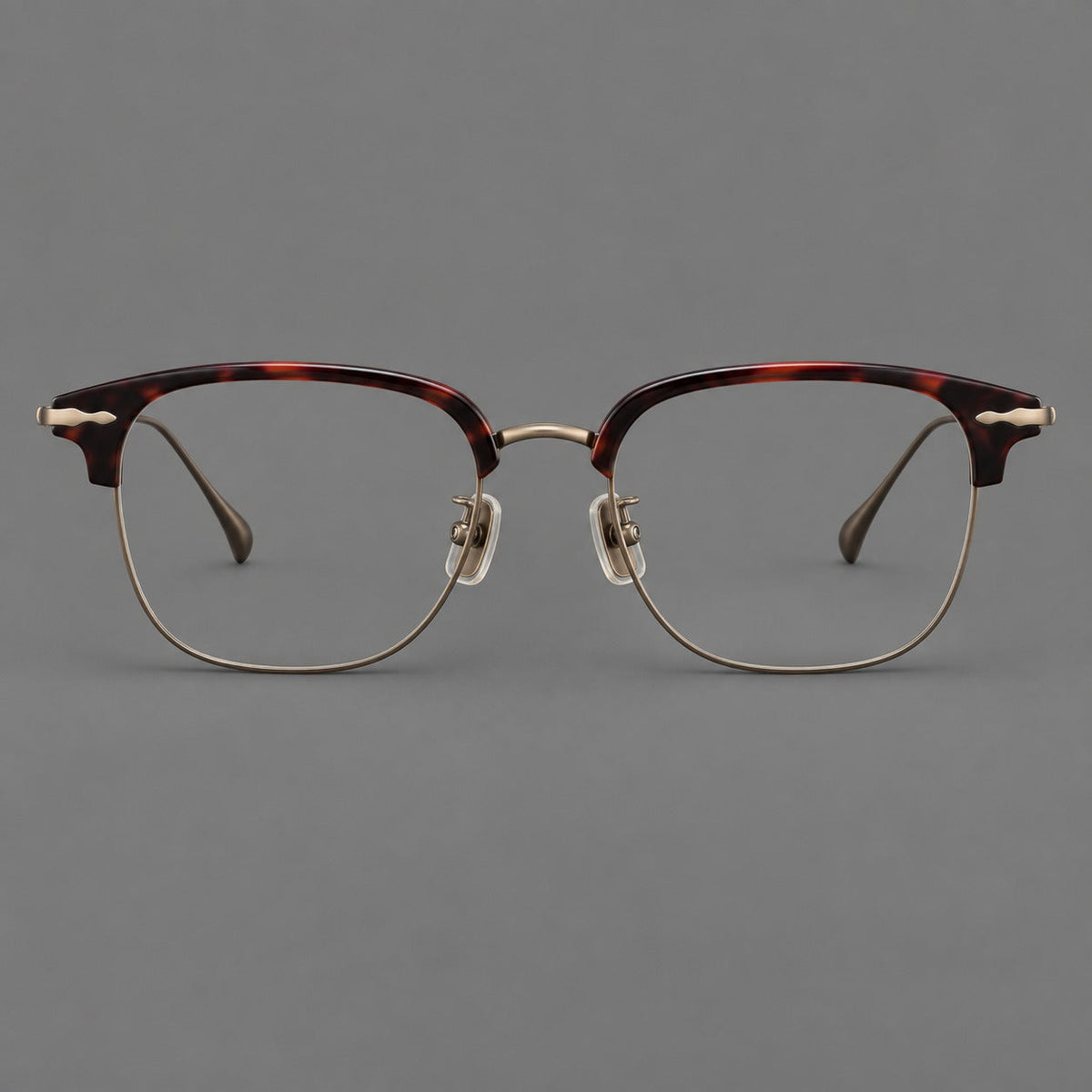 Browline eyeglasses in acetate and titanium with slim metal lower rims and decorative corners in Red Tortoiseshell / Antique Bronze, front view
