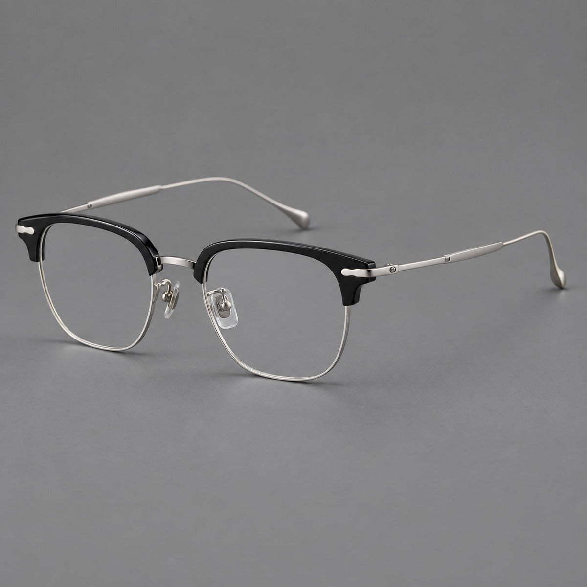 Browline eyeglasses in acetate and titanium with slim metal lower rims and decorative corners in Glossy Black / Silver, three quarter view