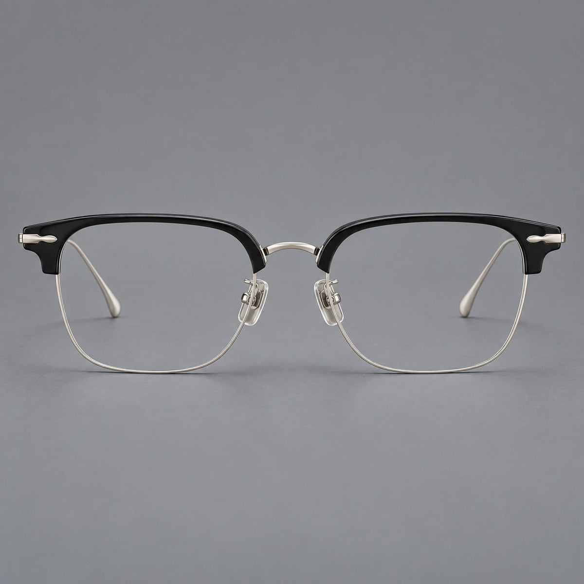 Browline eyeglasses in acetate and titanium with slim metal lower rims and decorative corners in Glossy Black / Silver, front view