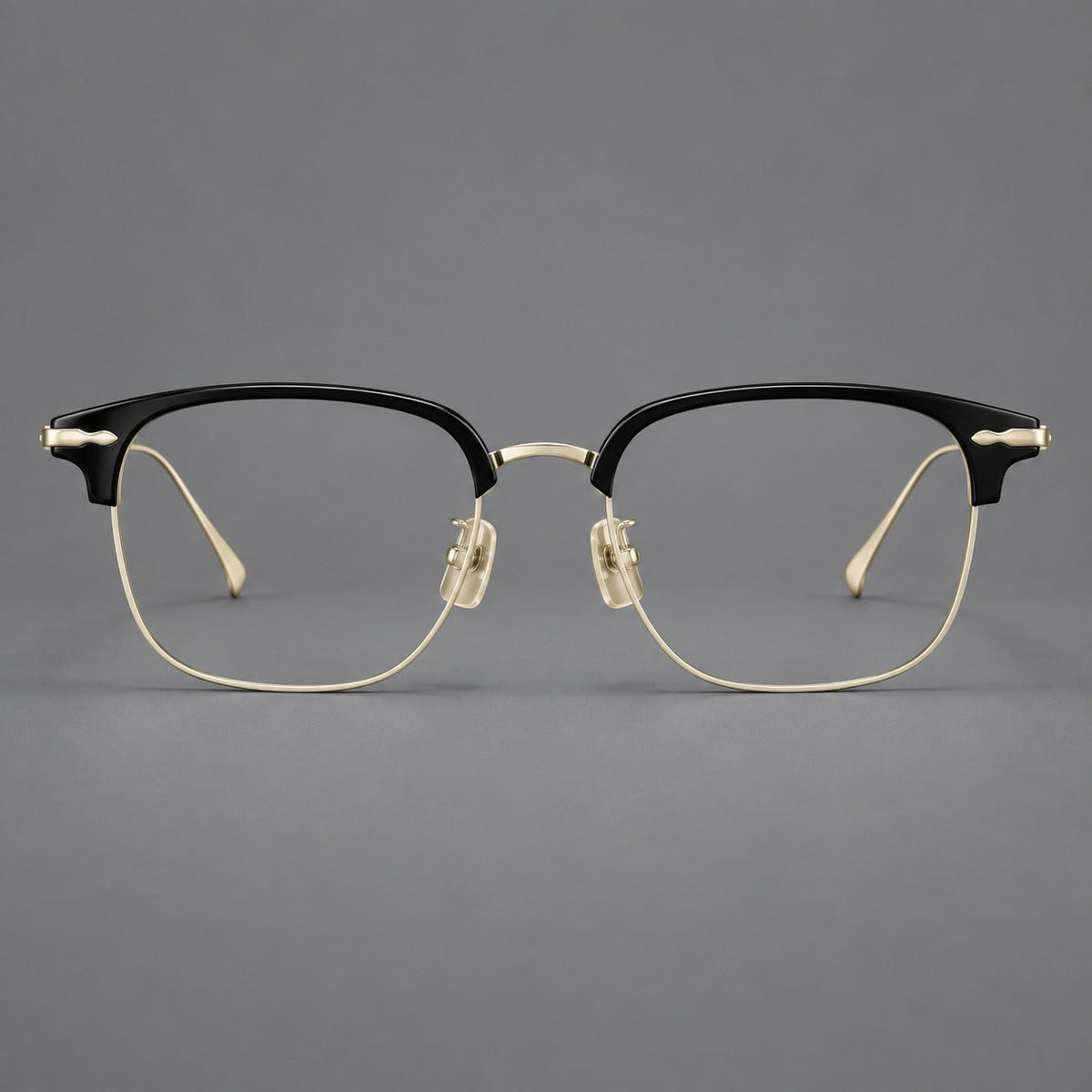 Browline eyeglasses in acetate and titanium with slim metal lower rims and decorative corners in Glossy Black / Gold, front view
