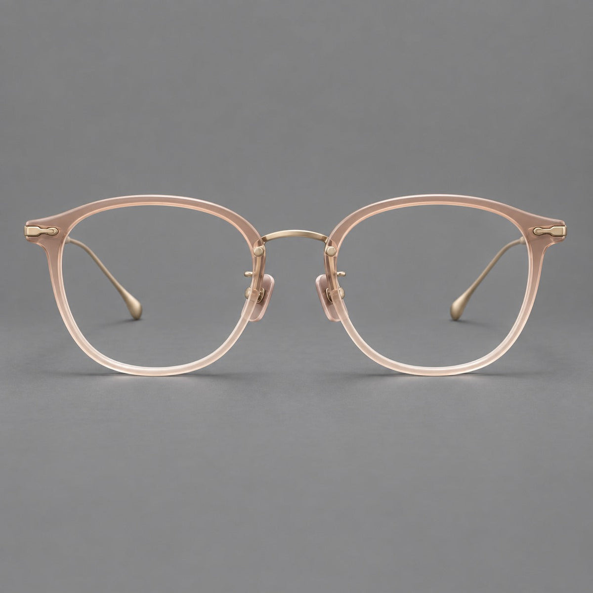 Panto eyeglasses in acetate and titanium with curved brows and decorative metal corner accents in Nude Pink / Gold, front view